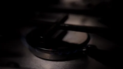 Slow motion - Blue flame gas burning from a Kitchen cooker stove hob, cooking Stock Footage 86535701