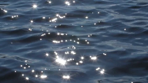 Slow motion blue lake water with brilliant sparkles from sun. Stock Footage