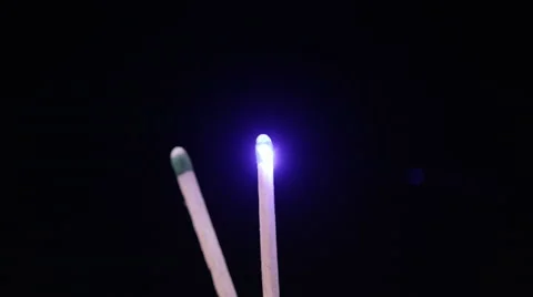 Slow motion of blue laser pointer lighting a match Stock Footage 62322650