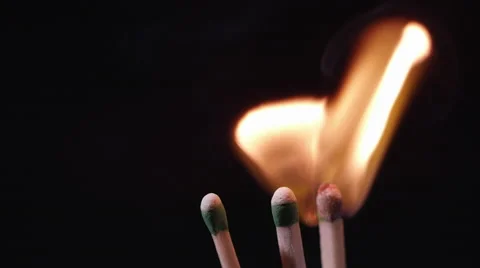 Slow motion of blue laser pointer lighting a match Stock Footage 62324251