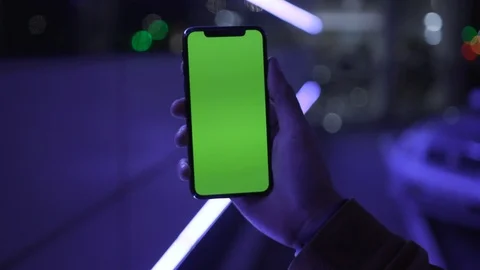 Slow motion blue light young man hands holding use smartphone with vertical Stock-Footage 111604848