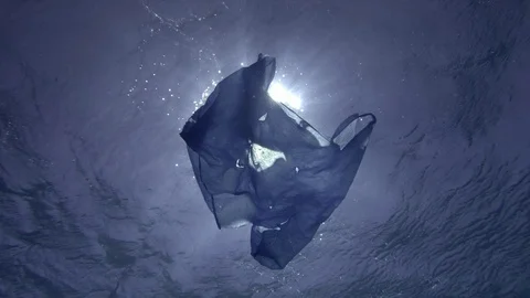 Slow Motion, Blue plastic bag slowly drifting underwater surface of water Stock Footage 123287703
