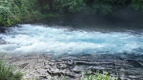 Slow motion blue river rapids and splashing white water Stock Footage 341175495