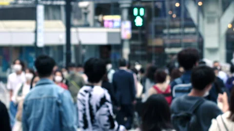 Slow motion blur of pedestrian crossing street upon green light during evening Stockbeeldmateriaal 196077516
