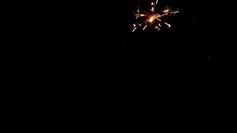 A slow motion of blured Bengali fire against the black background. Christmas Stock Footage 104678699
