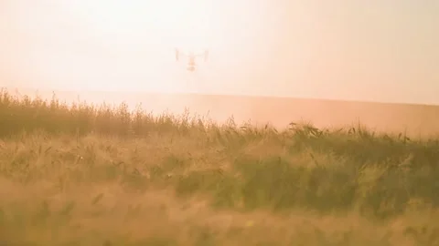 Slow motion of blurred background with flying quadcopter during sunset. Footage Stock Footage 201463233