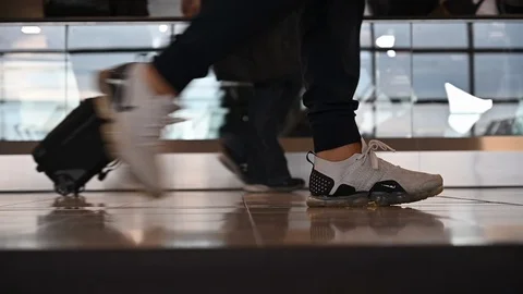 Slow motion of  blurred passengers walking on airport  Stock Footage 126006655