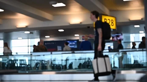 Slow motion of  blurred passengers walking on airport  Stock Footage 126007088