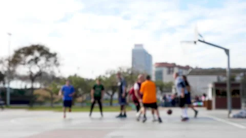 Slow motion blurred shot of men dribbling and shooting for basketball hoop Видео 132646508