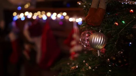 Slow motion, blurry, blond boy hangs Christmas stocking on wood mantle Stock Footage 99399647