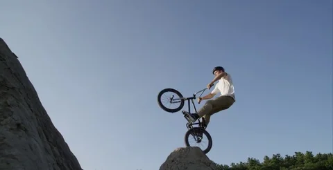 Slow motion BMX bar spin on big jump slow motion Stock Footage 80070878