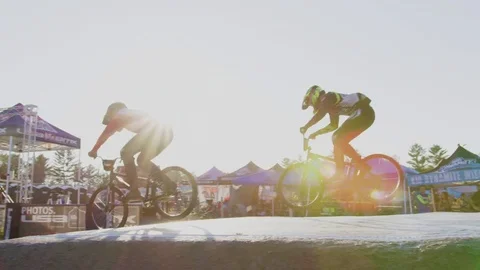 Slow Motion BMX Racing Jumping at Sunset Stock Footage 82049022