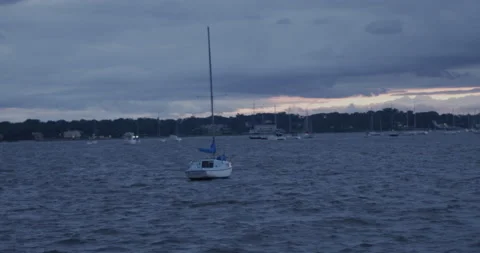 Slow motion Boat floating in the ocean at sunset Stock Footage 169660421