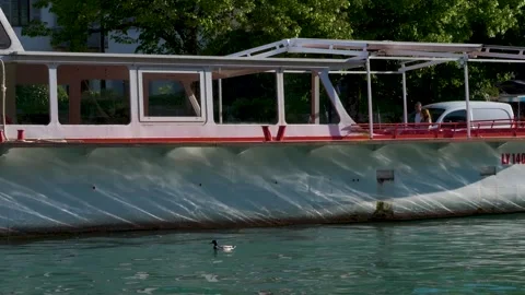 Slow motion boat standing docked in port in sunny day with passing tourist co Stock Footage 157007633