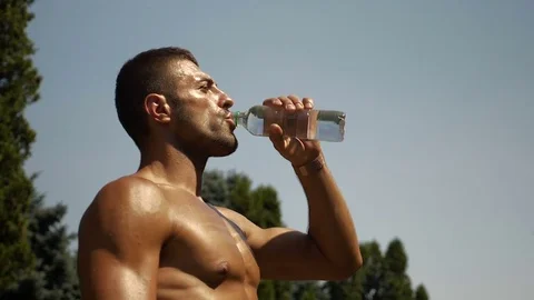 Slow motion of body builder drinking water from plastic bottle Stock Footage 78928093