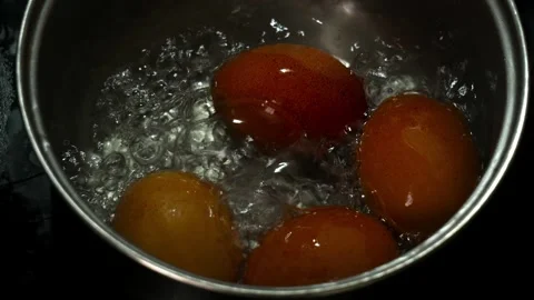 Slow Motion Boiling Brown Eggs in Pot with Bubbling Water Close Up 動画素材 330183891