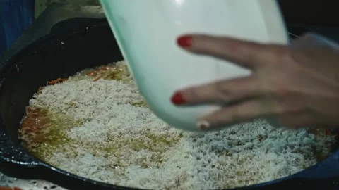 Slow motion of boiling rice in cauldron. Cooking for a big family. Stock Footage 170154661