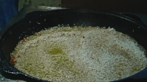 Slow motion of boiling rice in cauldron. Cooking for a big family. Stock Footage 170154724