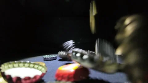 Slow Motion Bottle Caps Falling in Spot Light Stock Footage 287487983
