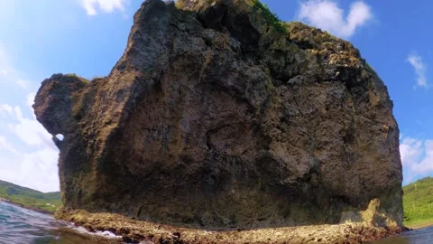 Slow motion of bottom moving up vertical pane view of back side Chuanfan Rock at Stock Footage 312399952