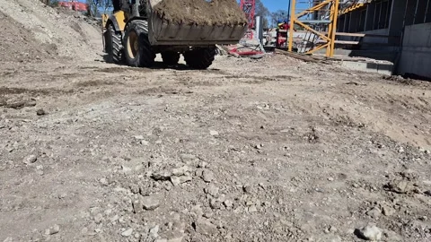 Slow Motion Bottom View of Construction Vehicle Moving Earth Stock Footage 335643890