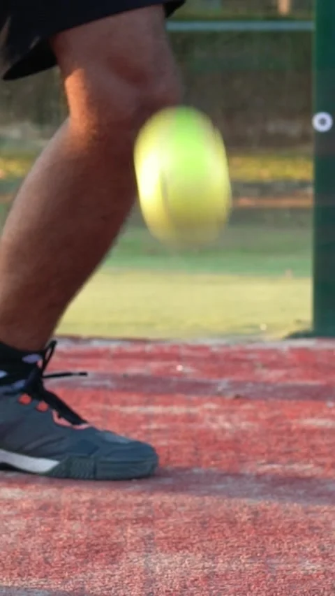 Slow motion of a bouncing ball before taking a paddle kick. Paddle player's leg. Stock Footage 312025386