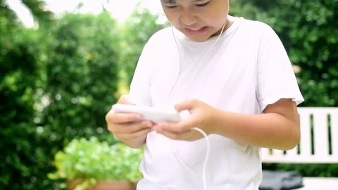 Slow motion boy feel headache during play smartphone Stock Footage 80295717