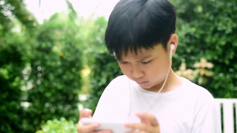 Slow motion boy feel headache during play smartphone Stock Footage 85382208