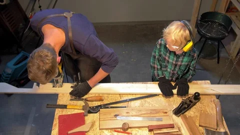 Slow motion, boy helps man in apron in the workshop Stock Footage 126711471