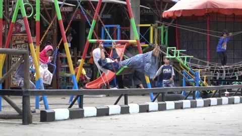 Slow Motion boy helps the younger sister swing Video stock 144436531