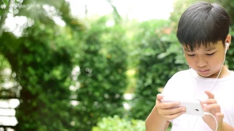 Slow motion boy play smartphone Stock Footage 80295719