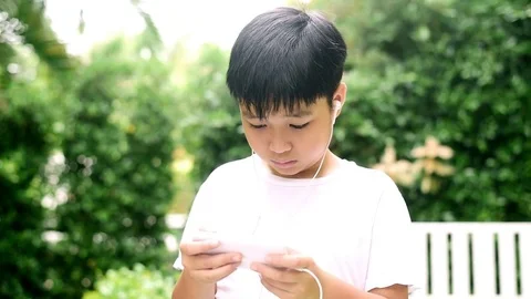 Slow motion boy play smartphone and feel headache Stock Footage 80555550