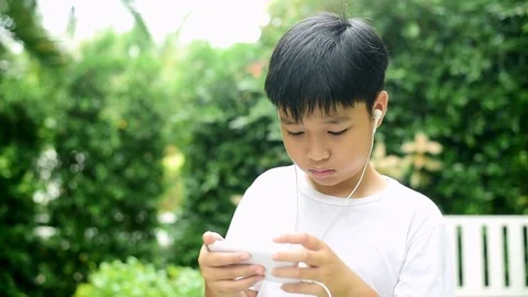 Slow motion boy playing game in smartphone Stock Footage 81028283