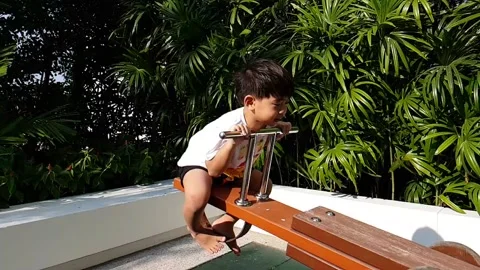 Slow motion a boy playing seesaw Stock Footage 150479458