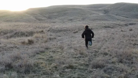 Slow motion boy running down the hill at sunset in autumn Stock Footage 105028069