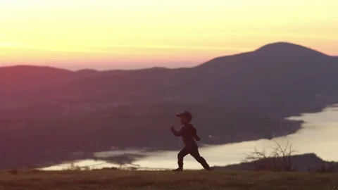 Slow motion. Boy running to his moter at the sunset in mountains Video stock 82557191