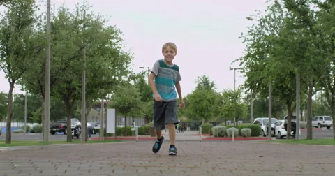 Slow Motion Boy Struts Toward the Camera Stock Footage 61651810
