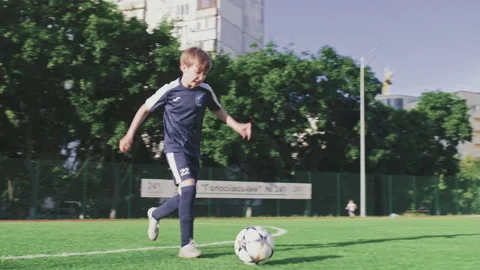 SLOW MOTION - Boy trains professionally on a football field with a ball. Stock Footage 158011518