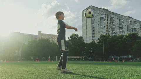 SLOW MOTION - Boy trains professionally on a football field with a ball. Trai Stock-Footage 158011627