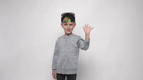 Slow motion. Boy waving his hand showing hello goodbye gesture Stock Footage 282201751