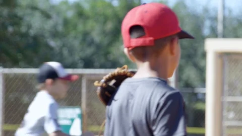 Slow motion of boy wearing baseball glove during practice and catching ball Stock Footage 93716326