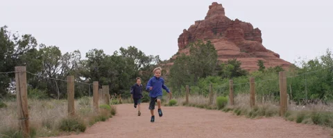 Slow Motion Boys Running and Jumping on a Hiking Trail Stock Footage 61719367