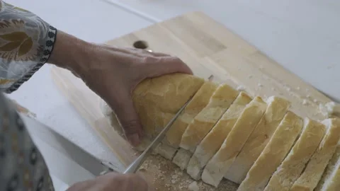 Slow Motion Bread Cut by Knife Stock Footage 169535192