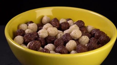 Slow motion. Breakfast pouring milk into corn flakes Stock Footage 122854447