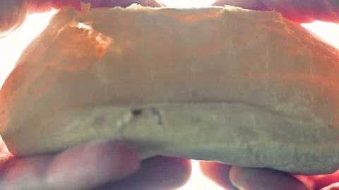 Slow motion of breaking bread with  hands Stock Footage 148351513