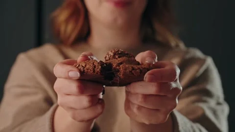 Slow motion breaking chocolate cookie in half close up Stock Footage 331185185