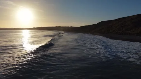 Slow Motion Breaking Ocean Wave Near Coastline at Sunset in 4K Stock-Footage 332944617