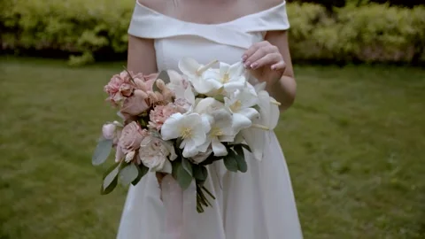 Slow motion. The bride holds a wedding bouquet. Stock Footage 164559864