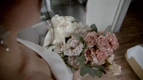 Slow motion. The bride holds a wedding bouquet of white and pink flowers. Stock Footage 164596374