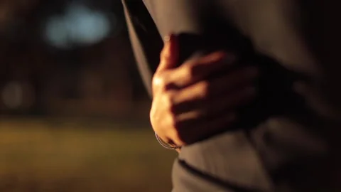 Slow motion of a bride hugging her husband's back during sunset Stock Footage 135212899